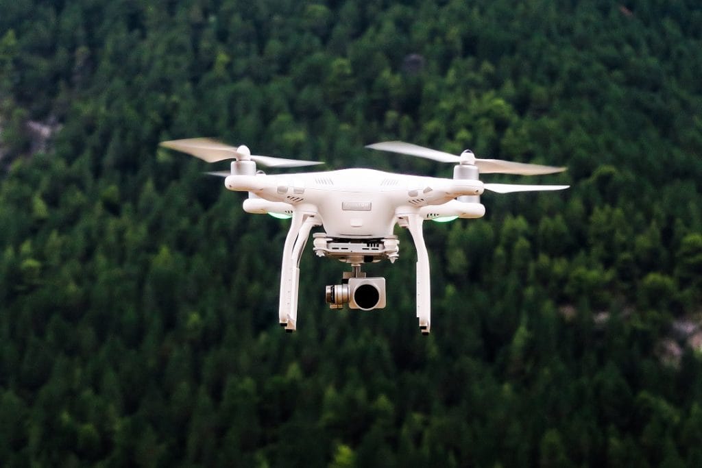 Drone flying with trees in the background