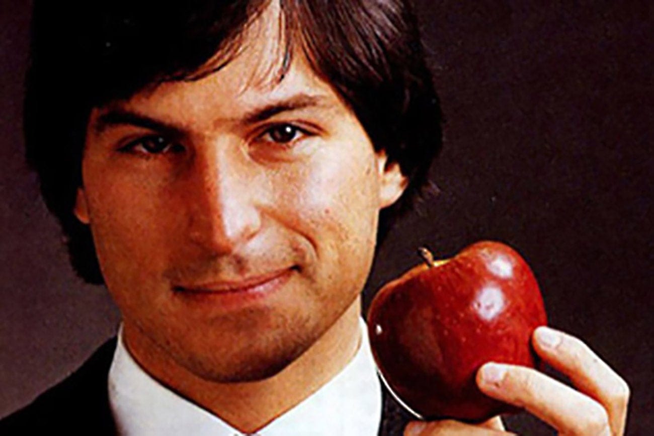 Steve Jobs holding an apple